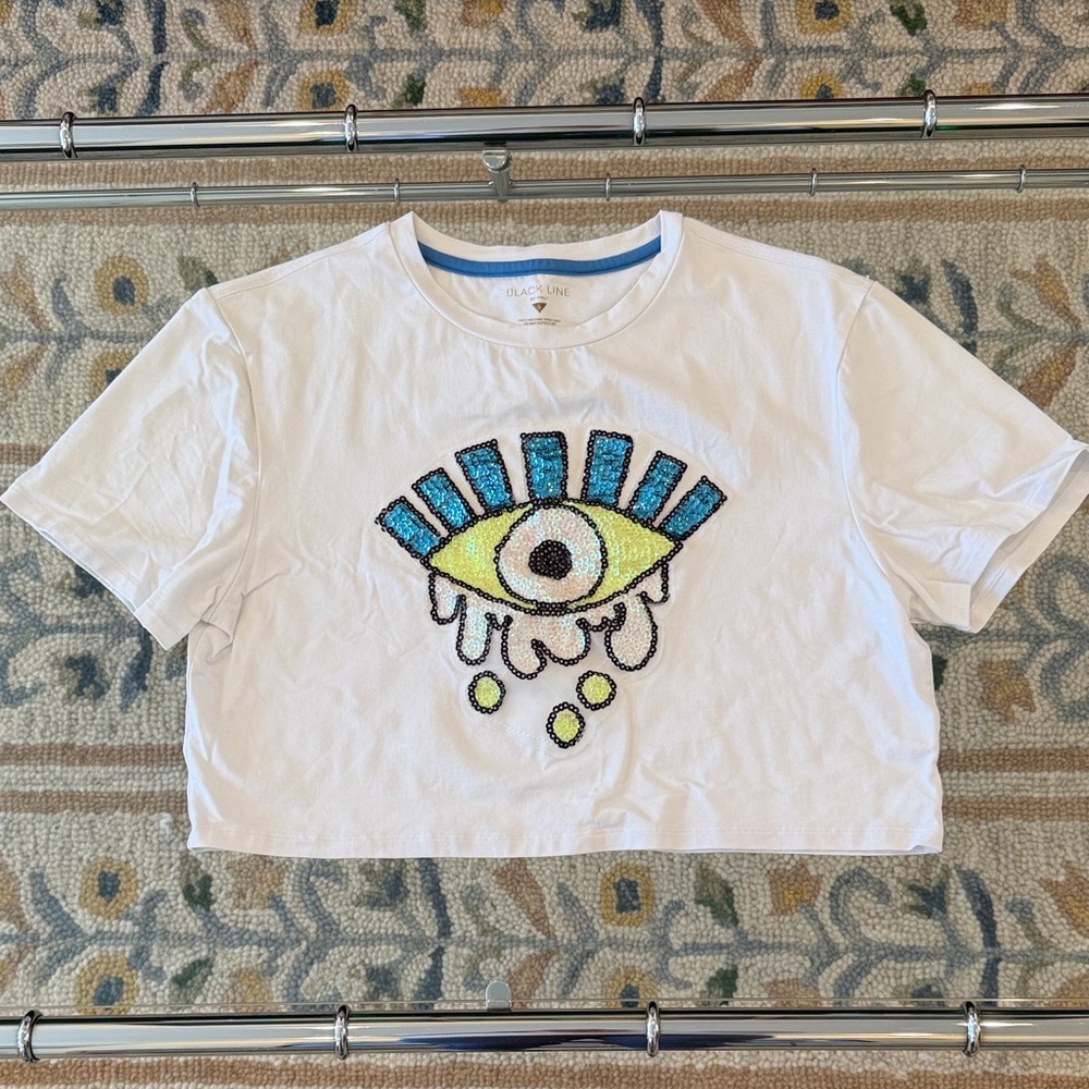 Noli White Tee with Blue and Yellow Eye Design